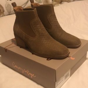 Brown suede ankle boots with subtle snake pattern.